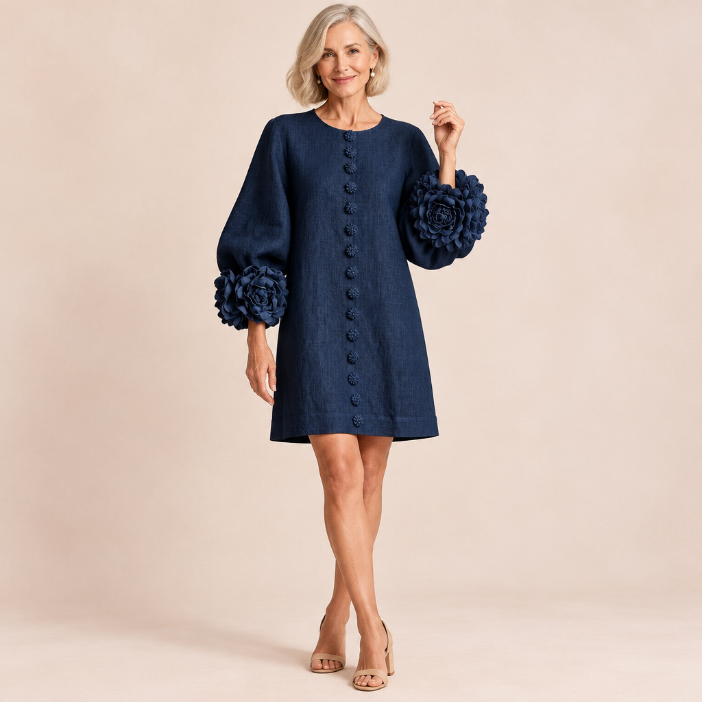Woman wearing the Aurora easy-fit button-front dress with floral cuffs in navy