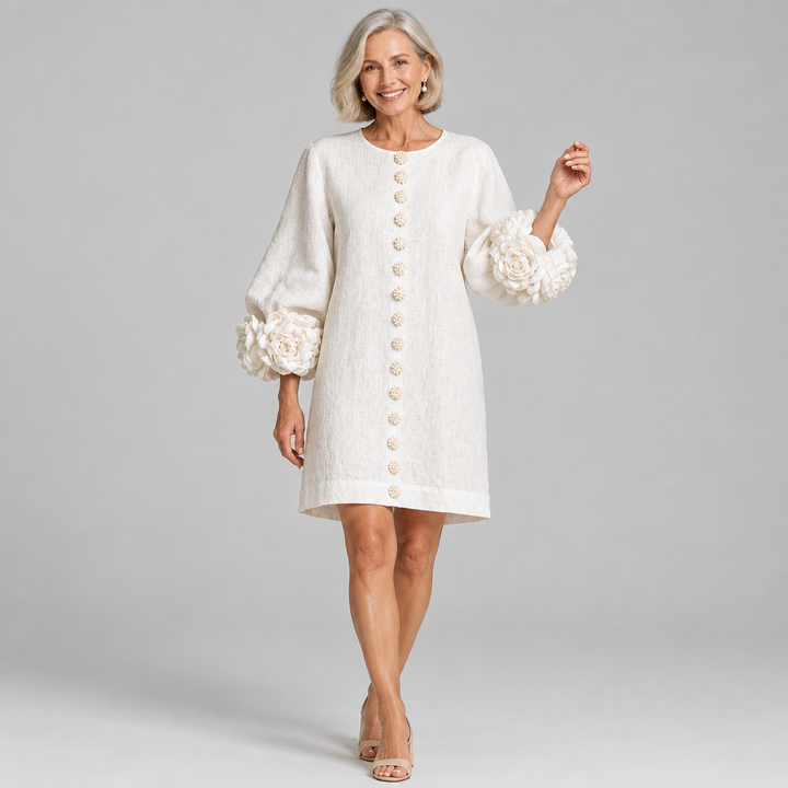 Woman wearing the Rosalie relaxed button-down dress with rose-knot cuffs