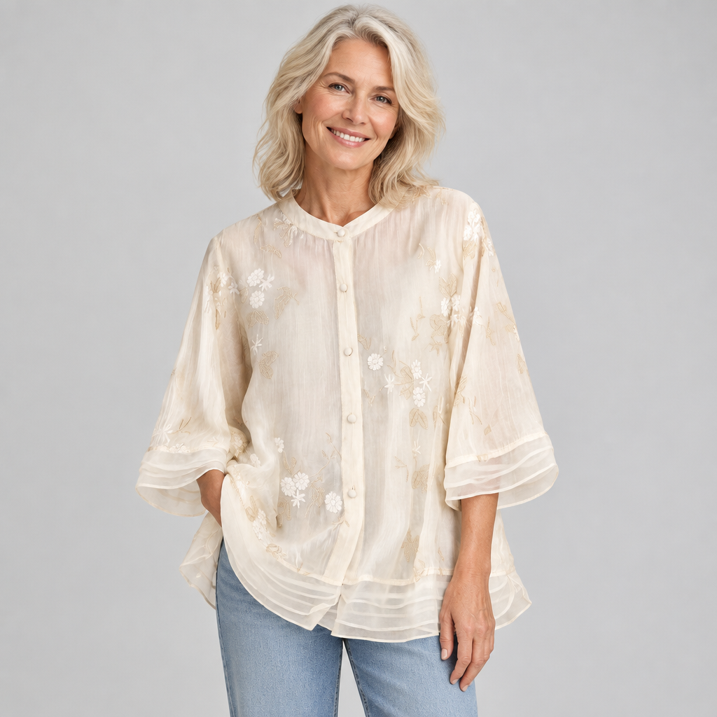 Woman wearing the Emily soft cotton top with embroidered flowers in cream