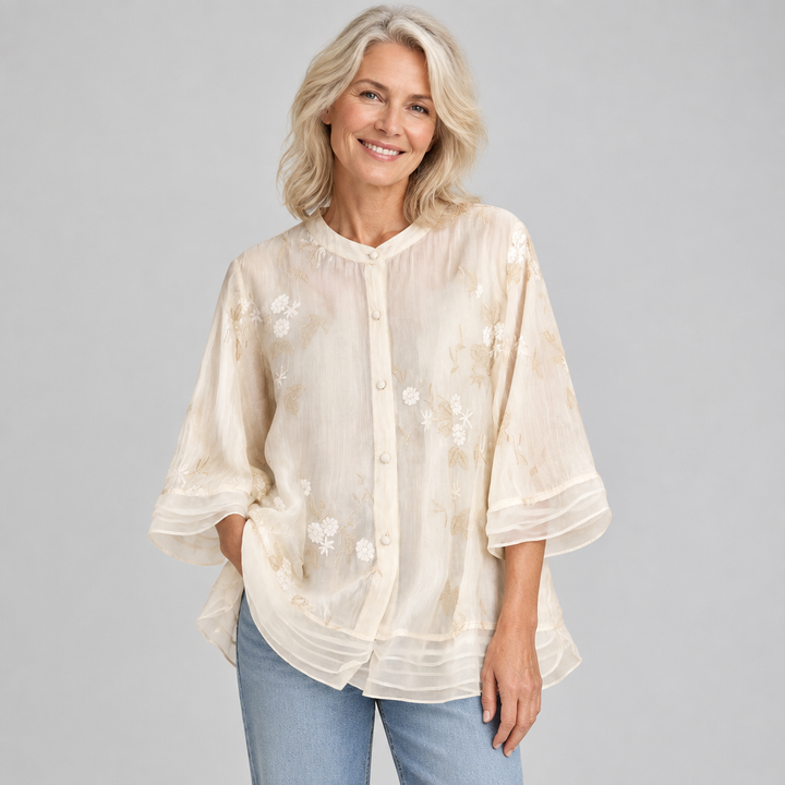 Woman wearing the Emily soft cotton top with embroidered flowers in cream