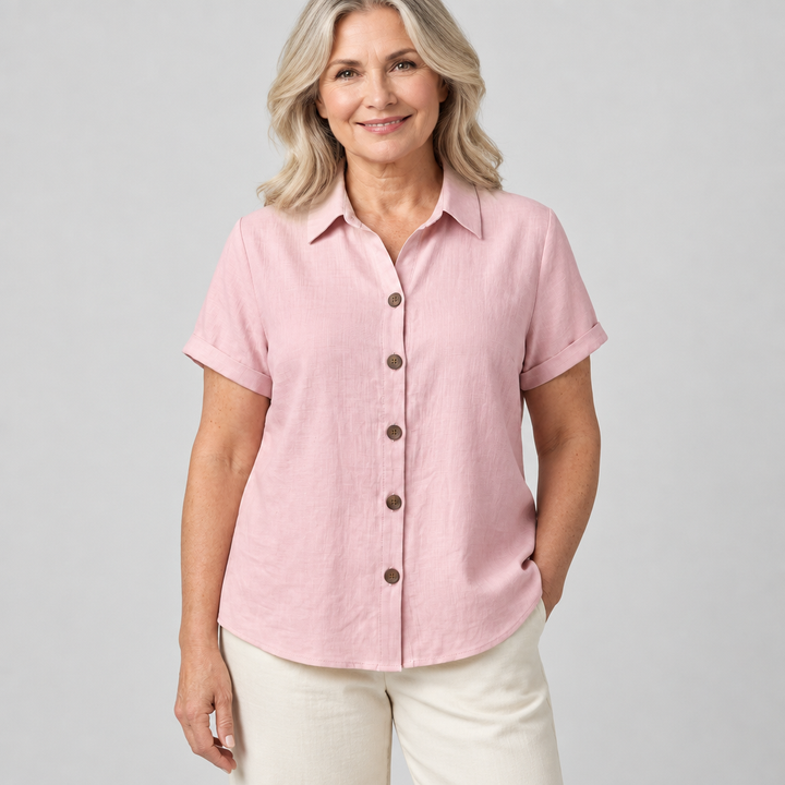 Woman wearing the classic button-front blouse in pink