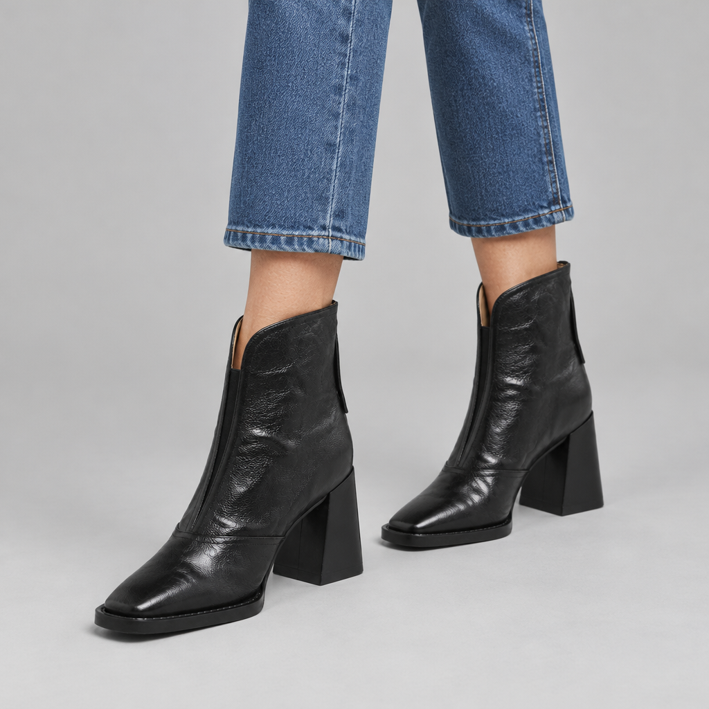 Woman wearing the Aria block heel square-toe ankle boots with jeans